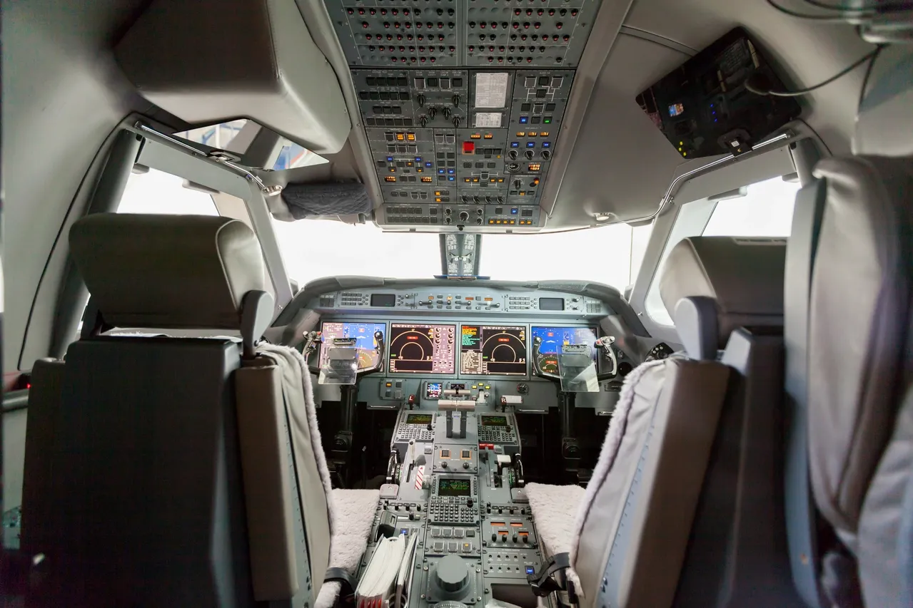 Modern aircraft cockpit with integrated multi-screen glass displays, representing the software and hardware systems covered by the Programmable Elements Certification course